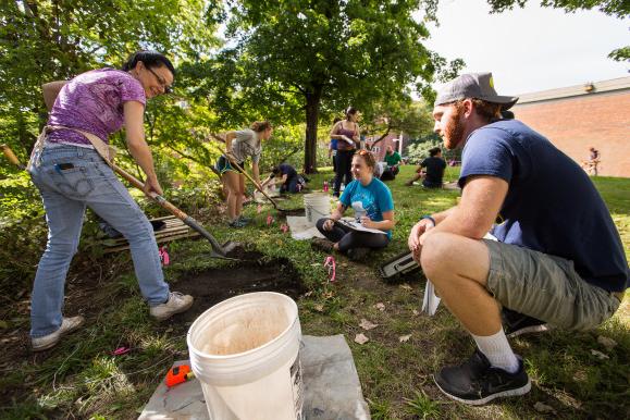 Professor of Anthropology Shannon Fie demonstrates to a class proper archaeological techniques on the Beloit College campus.